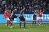 Players stand between tennis balls on the pitch, thrown by Union fans to protest against investors, during the German Bundesliga soccer match between VfL Bochum and Union Berlin in Bochum, Germany, Saturday, Dec. 16, 2023. (AP Photo/Martin Meissner)
