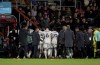 Luton Town's players make their way to the dressing room as their team mate Tom Lockyer receives treatment on the pitch, during the English Premier League soccer match between Bournemouth and Luton Town at the Vitality Stadium, in Bournemouth, England, Saturday, Dec. 16, 2023. (Steven Paston/PA via AP)