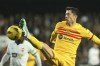 Barcelona's Robert Lewandowski challenges for the ball during the Spanish La Liga soccer match between Valencia and Barcelona at the Mestalla stadium in Valencia, Spain, Saturday, Dec. 16, 2023. (AP Photo/Alberto Saiz)