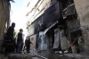 Palestinians look at the aftermath of the Israeli military raid on Nur Shams refugee camp in the West Bank on Sunday, Dec. 17, 2023. (AP Photo/Majdi Mohammed)