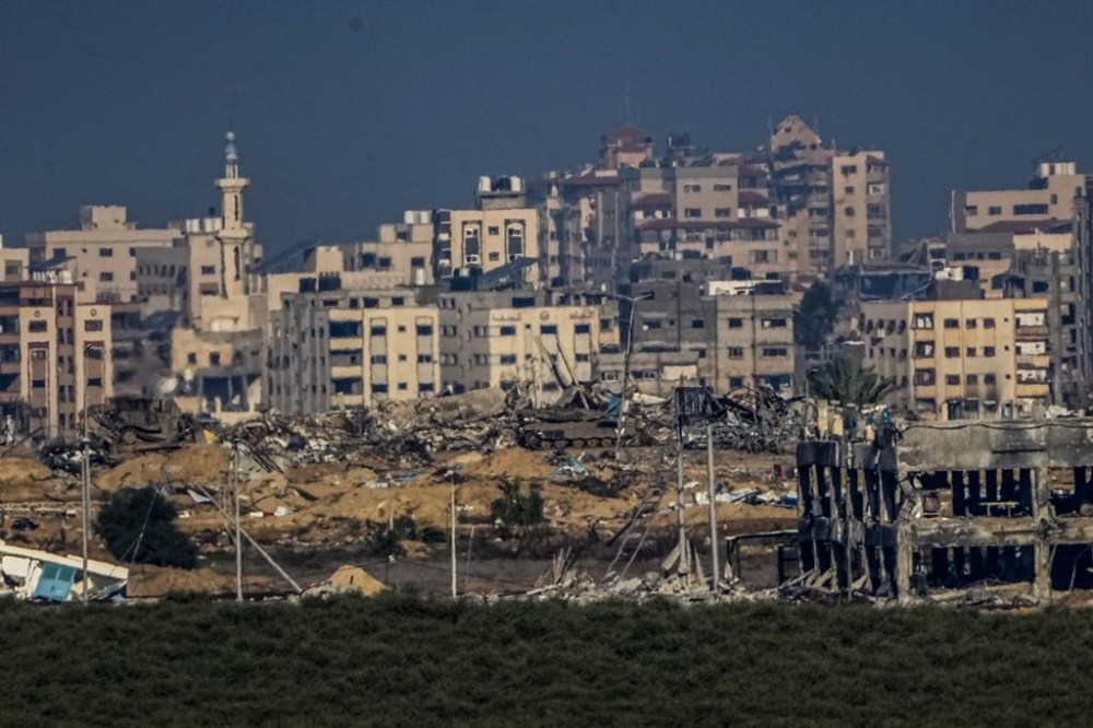 Israeli military vehicles operate inside Gaza Strip, as seen from southern Israel, Sunday, Dec. 17, 2023. (AP Photo/Ariel Schalit)