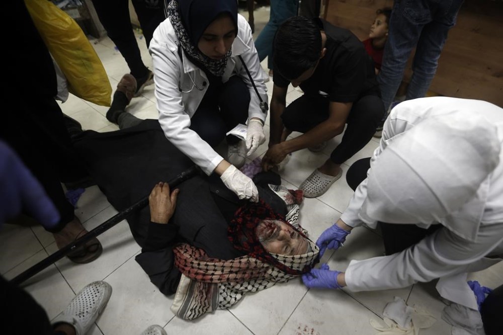 A Palestinian man wounded in Israeli airstrikes on a U.N.-run school receives treatment at the Nasser hospital in the town of Khan Younis, southern Gaza Strip. Sunday, Dec. 17, 2023. (AP Photo/Mohammed Dahman)