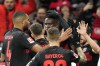 Leverkusen's Victor Boniface is celebrated by teammates after he scored the opening goal during the German Bundesliga soccer match between Bayer Leverkusen and Eintracht Frankfurt at the BayArena in Leverkusen, Germany, Sunday, Dec. 17, 2023. (AP Photo/Martin Meissner)