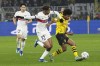 Dortmund's Karim Adeyemi, right, and PSG's Bradley Barcola challenge for the ball during the Champions League Group F soccer match between Borussia Dortmund and Paris Saint-Germain at the Signal Iduna Park in Dortmund, Germany, Wednesday, Dec. 13, 2023. (AP Photo/Martin Meissner)