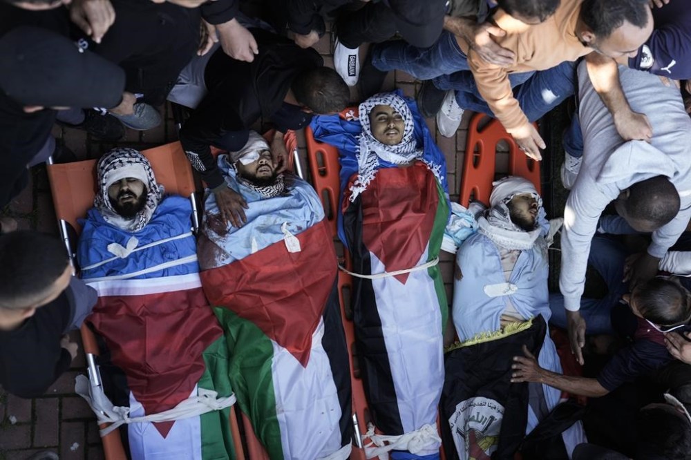 Friends and relatives attend the funeral of Palestinians killed during an Israeli military raid on the Fara'a refugee camp in the West Bank on Monday, Dec. 18, 2023. (AP Photo/Majdi Mohammed)