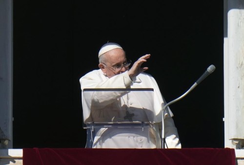 Pope Francis waves during the Angelus noon prayer from the window of his studio overlooking St.Peter's Square, at the Vatican, Sunday, Dec. 17, 2023. (AP Photo/Alessandra Tarantino)