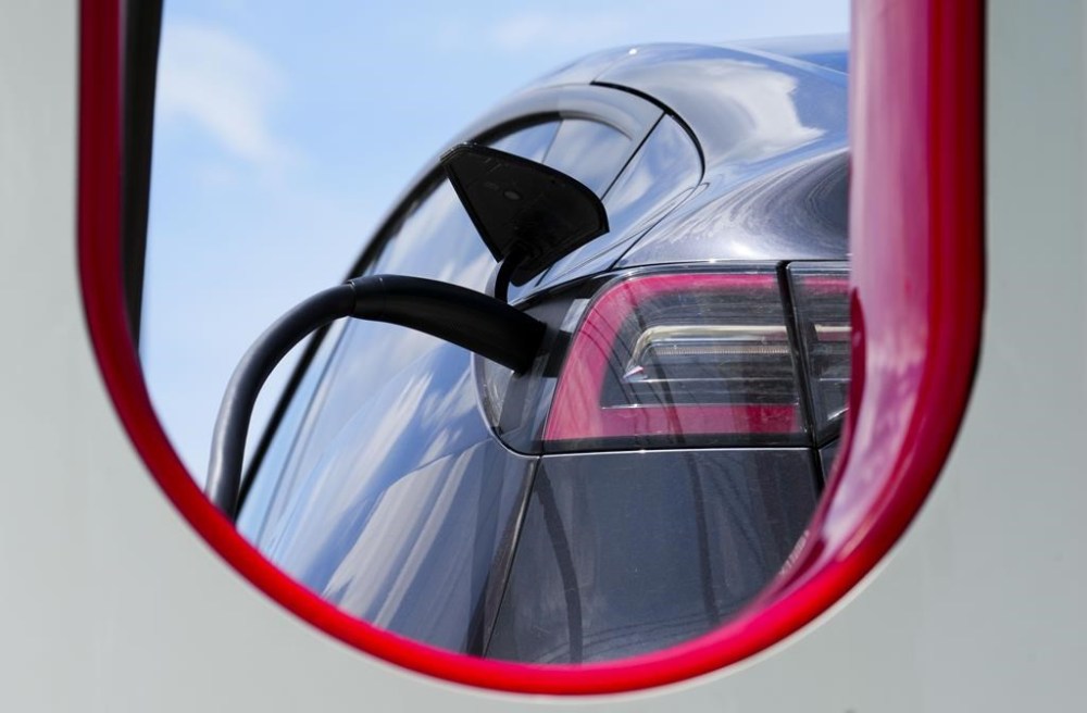 An electric vehicle is charged in Ottawa on Wednesday, July 13, 2022. Auto manufacturers will have three years to start showing a sizable increase in electric vehicle sales as the federal government moves to finalize its new EV mandate this week. THE CANADIAN PRESS/Sean Kilpatrick