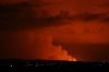 The night sky is illuminated caused by the eruption of a volcano on the Reykjanes peninsula of south-west Iceland seen from the capital city of Reykjavik, Monday Dec. 18, 2023. (AP Photo/Brynjar Gunnarsson)