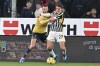 Juventu's Andrea Cambiaso, right, and Genoa's Mattia Bani fight for the ball during the Serie A soccer match between Genoa CFC and Juventus Turin at the Luigi Ferraris stadium in Genoa, Italy, Friday Dec. 15, 2023. (Tano Pecoraro/LaPresse via AP)