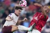 Manchester City's John Stones fights for the ball with Urawa Reds' Jose Kante, right, during the Soccer Club World Cup semifinal soccer match between Urawa Reds and Manchester City FC at King Abdullah Sports City Stadium in Jeddah, Saudi Arabia, Tuesday, Dec. 19, 2023. (AP Photo/Manu Fernandez)