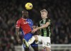 Crystal Palace's Jean-Philippe Mateta, left, and Brighton and Hove Albion's Jan Paul van Hecke battle for the ball during the English Premier League soccer match at Selhurst Park, London, Thursday Dec. 21, 2023. (Adam Davy/PA via AP)