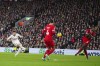 Manchester United's Scott McTominay, left, shoots on target during the English Premier League soccer match between Liverpool and Manchester United at the Anfield stadium in Liverpool, England, Sunday, Dec.17, 2023. (AP Photo/Jon Super)