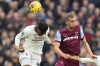 Manchester United's Willy Kambwala, left, jumps for a header with West Ham's Tomas Soucek during the English Premier League soccer match between West Ham United and Manchester United at the London stadium in London, Saturday, Dec. 23, 2023. (AP Photo/Kirsty Wigglesworth)