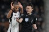 Referee Rebecca Welch gestures next to Fulham's Bobby Decordova-Reid during the English Premier League soccer match between Fulham and Burnley at Craven Cottage stadium in London, Saturday, Dec. 23, 2023. Welch is the first female referee ever to officiate an English Premier League game. (AP Photo/Alastair Grant)