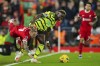 Liverpool's Kostas Tsimikas, left, is fouled by Arsenal's Bukayo Saka during the English Premier League soccer match between Liverpool and Arsenal at Anfield stadium in Liverpool, England, Saturday, Dec. 23, 2023. (AP Photo/Jon Super)