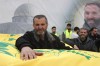 Ahmad Bazzi, the father of a Hezbollah fighter mourns over one of his sons coffin during their funeral processions, in Bint Jbeil, South Lebanon, Wednesday, Dec. 27, 2023. One Hezbollah fighter and two civilians, a newlywed couple, were killed in an overnight Israeli strike on a family-owned residential building in the town of Bint Jbeil, local residents and state media said Wednesday.(AP Photo/Mohammed Zaatari)