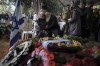 The wife, center, of the Israeli staff sergeant Elisha Yehonatan Lober, who was killed in battle in the Gaza Strip, mourns during the funeral of her husband at the Mount Herzl military cemetery in Jerusalem, Israel, Wednesday, Dec. 27, 2023. (AP Photo/Leo Correa)
