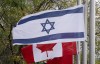The flags of Canada and Israel fly at half mast at a community building on Wednesday, October 11, 2023 in Ottawa. Friends, family and government officials have confirmed that at least seven Canadians were killed when Hamas militants conducted a series of attacks in Israel on Oct. 7. THE CANADIAN PRESS/Adrian Wyld