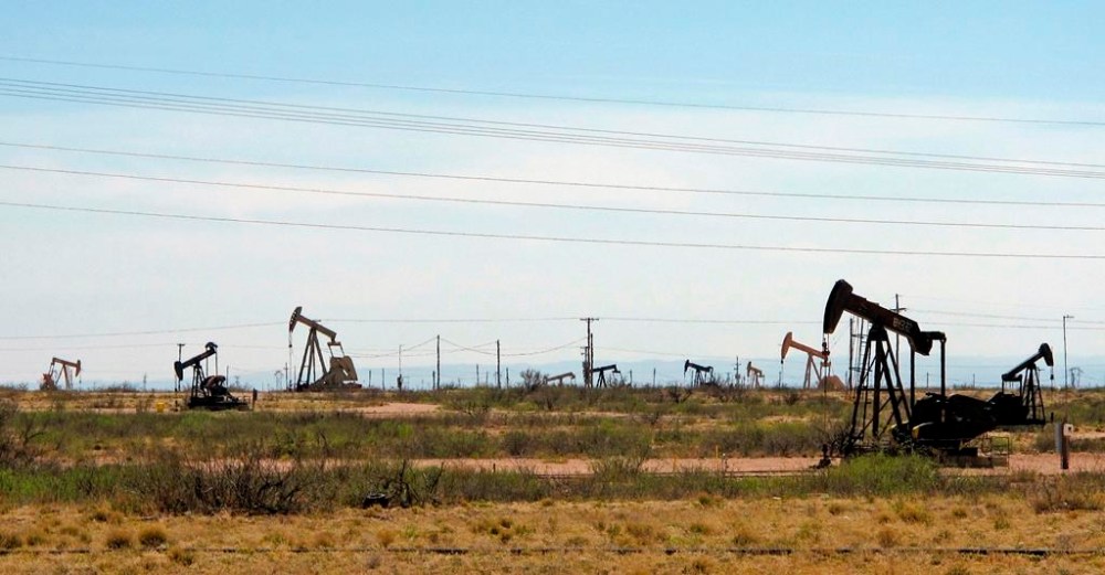 FILE - Oil rigs stand in the Loco Hills field on April 9, 2014, on in Eddy County near Artesia, N.M.. The state's environmental regulators have proposed a new regulatory framework for reusing wastewater with a major focus on treating and repurposing the used, salty byproducts of oil and natural gas drilling in a major U.S. petroleum production zone. The EPA announced Thursday, Dec. 28, 2023, its petition to the state Water Quality Control Commission to begin formal deliberations on the proposed rules. (AP Photo/Jeri Clausing, File)