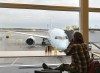 A new report says Air Canada had the worst on-time performance among large airlines in North America in 2023. A traveller looks at an Air Canada plane as he waits for his flight at Pierre Elliott Trudeau International Airport in Montreal, Friday, Dec. 23, 2023. THE CANADIAN PRESS/Christinne Muschi