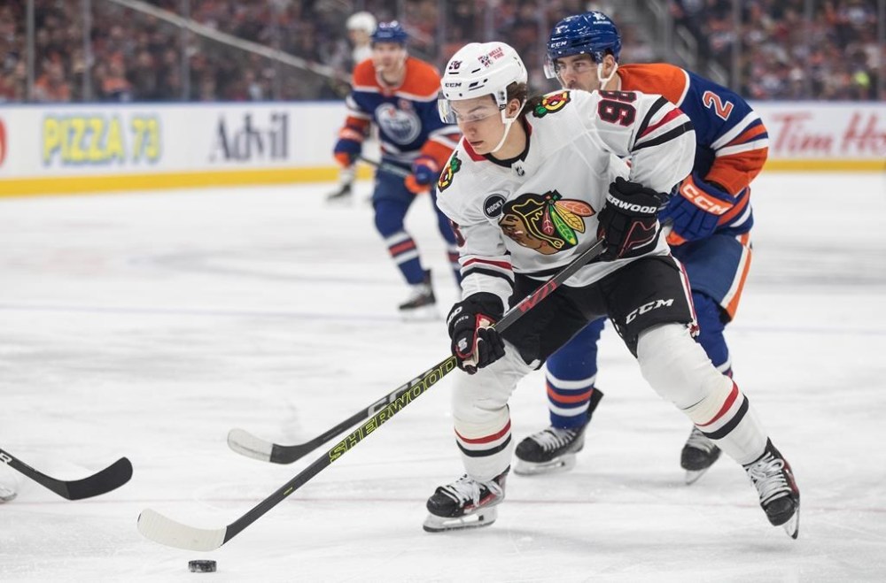Chicago Blackhawks' Connor Bedard (98) pulls away from Edmonton Oilers' Evan Bouchard (2) during first period NHL action in Edmonton on Tuesday, Dec. 12, 2023. Bedard has been named the NHL's rookie of the month for December. THE CANADIAN PRESS/Jason Franson