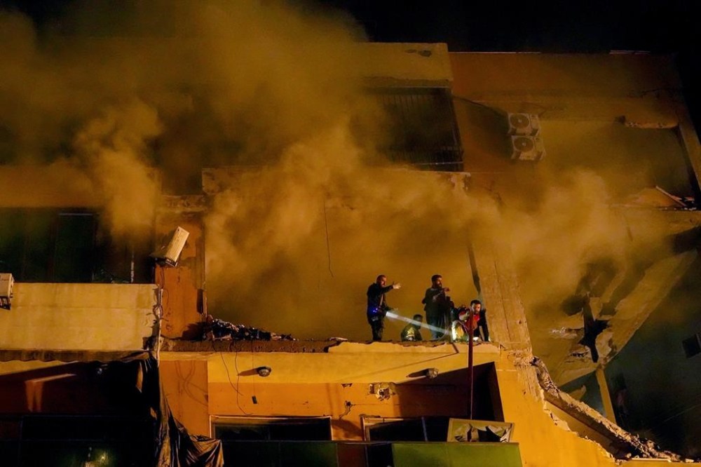 Smoke rises from a destroyed apartment as civil defense workers search for survivors following a massive explosion in the southern Beirut suburb of Dahiyeh, Lebanon, Tuesday, Jan. 2, 2024. An explosion killed Saleh Arouri, a top official with the Palestinian militant group Hamas and three others, officials with Hamas and the Lebanese group Hezbollah said. (AP Photo/Bilal Hussein)