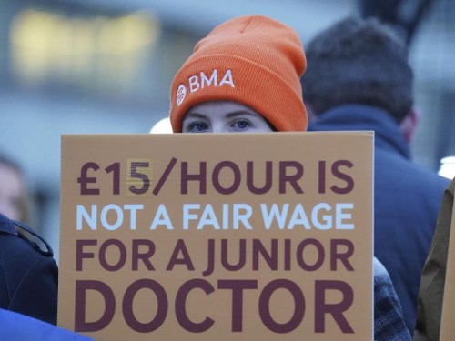 Junior doctors and members of the British Medical Association (BMA) demonstrate outside St Thomas' Hospital, London, Wednesday, Jan. 3, 2024, as they take to picket lines for six days. Doctors in the early stages of their careers in England have started a 72-hour strike in their long-running dispute over pay levels. (Jonathan Brady/PA via AP)