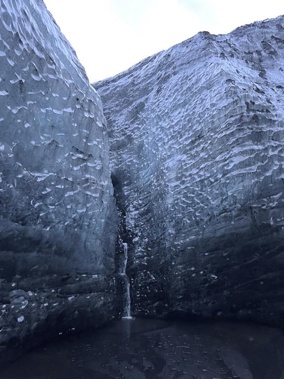 This Nov. 18, 2023 image provided by Beth Harpaz shows the icy blue walls of an ice cave at Vatnajokull National Park, located on an ice field in southeastern Iceland. The caves can only be explored on a tour with a registered guide. Winter crampons must be attached to shoes and boots for traction to avoid slipping. (Beth Harpaz via AP)