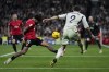 Real Madrid's Dani Carvajal tries to beat Mallorca's goalkeeper Predrag Rajkovic in front of the pressure of Mallorca's Samu Costa during the Spanish La Liga soccer match between Real Madrid and Mallorca at the Santiago Bernabeu stadium in Madrid, Spain, on Wednesday, January 3, 2024. (AP Photo/Bernat Armangue)