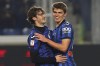 Atalanta's Aleksey Miranchuk, and Charles De Ketelaere, right, celebrate after scoring third goal during an Italian Cup, round of 16 soccer match between Atalanta and Sassuolo, at the Gewiss Stadium in Bergamo, Italy, Wednesday, Jan. 3, 2024. (Spada/LaPresse via AP)