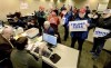Supporters of Republican presidential candidate Donald Trump submit nomination papers with state election authorities, Thursday, Jan. 4, 2024, at the State Board of Elections in Springfield, Ill. (Thomas J. Turney/The State Journal-Register via AP)