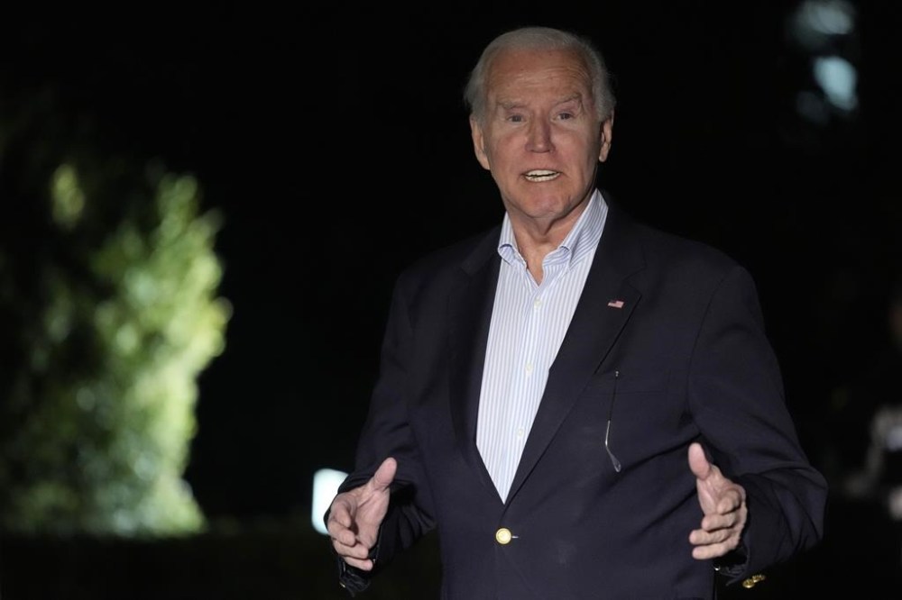 FILE - President Joe Biden responds to a question as he walks back to the White House in Washington, Jan. 2, 2024, after returning from a vacation with his family in the U.S. Virgin Islands. Biden is holding his first political event of 2024 near Valley Forge, Pa., on Friday, marking the third anniversary of the Capitol attack.(AP Photo/Susan Walsh, File)