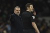 Tottenham's head coach Ange Postecoglou, left, speaks with line referee during the English FA Cup third round soccer match between Tottenham Hotspur and Burnley at the Tottenham Hotspur Stadium in London, Friday, Jan. 5, 2024. (AP Photo/Ian Walton)