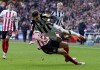 Sunderland's Luke O'Nien, left, challenges Newcastle United's Lewis Miley during the FA Cup, third round soccer match between Sunderland and Newcastle United at the Stadium of Light, Sunderland, England, Saturday, Jan. 6, 2024. (Owen Humphreys/PA via AP)