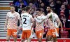 Blackpool's Albie Morgan, center, celebrates scoring their side's second goal of the game with teammates during the English FA Cup Third Round soccer match between Nottingham Forest and Blackpool at the City Ground, Nottingham, England, Sunday, Jan. 7, 2024. (Mike Egerton/PA via AP)