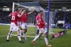 Wrexham's Thomas O'Connor, center, celebrates scoring their side's first goal of the game with teammates during their English FA Cup Third Round soccer match at The Croud Meadow, Shrewsbury, England, Sunday, Jan. 7, 2024. (Nick Potts/PA via AP)
