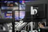A currency trader watches computer monitors near the screens showing the Korean Securities Dealers Automated Quotations (KOSDAQ), and the foreign exchange rate at a foreign exchange dealing room in Seoul, South Korea, Monday, Jan. 8, 2024. Major Asian stock markets traded lower after Wall Street closed its worst week since Halloween with a listless Friday.(AP Photo/Lee Jin-man)