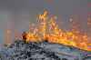 Scientist of the University of Iceland take measurements and samples standing on the ridge in front of the active part of the eruptive fissure of an active volcano in Grindavik on Iceland's Reykjanes Peninsula, Tuesday, Dec. 19, 2023. (AP Photo/Marco Di Marco)