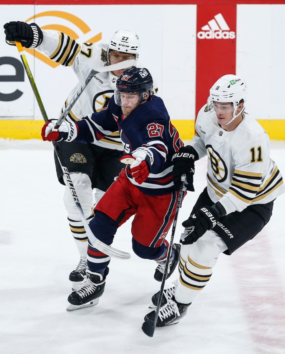 John Woods / THE CANADIAN PRESS
Winnipeg Jets' Nikolaj Ehlers breaks through Boston Bruins' Hampus Lindholm and Trent Frederic during the first period.