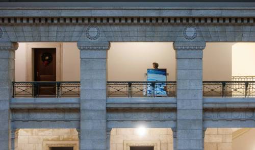 Amy Karlinsky, visual arts consultant with Manitoba's department of Sport, Culture, Heritage and Tourism, transports a painting through the halls of the Manitoba Legislative Building. (Mike Deal / Winnipeg Free Press)