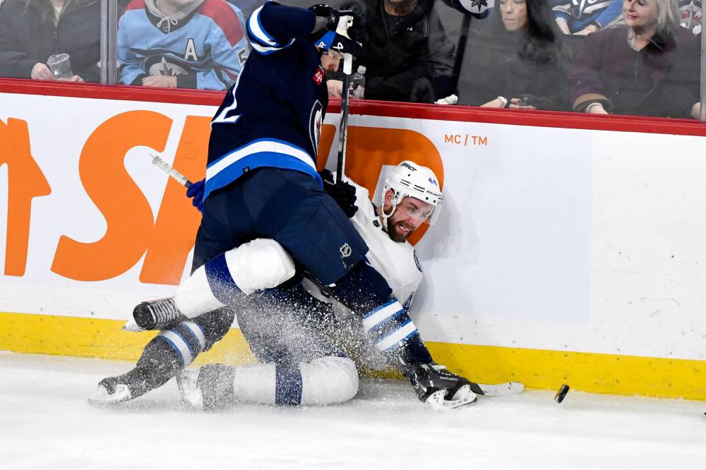 THE CANADIAN PRESS/Fred Greenslade
Tampa Bay Lightning Calvin de Haan (44) is checked by Winnipeg Jets’ Nino Niederreiter (62) during the first period.