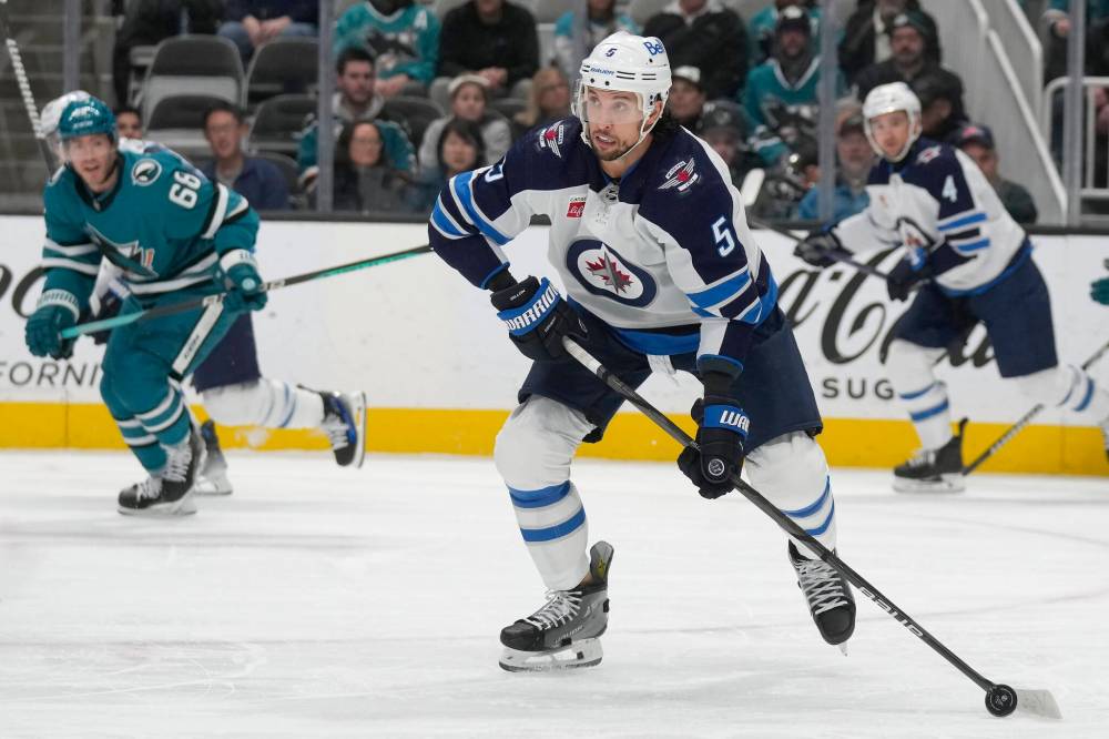 Winnipeg Jets defenceman Brenden Dillon looks to pass the puck against the San Jose Sharks during the first period. (AP Photo/Jeff Chiu)