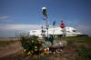 Flowers and other items placed at the intersection of the Trans-Canada Highway and Highway 5 just north of Carberry in June 2023 as a memorial to the victims of a collision involving a semi-trailer and a passenger bus carrying seniors from Dauphin to the Sand Hills Casino. (Tim Smith / The Brandon Sun files)