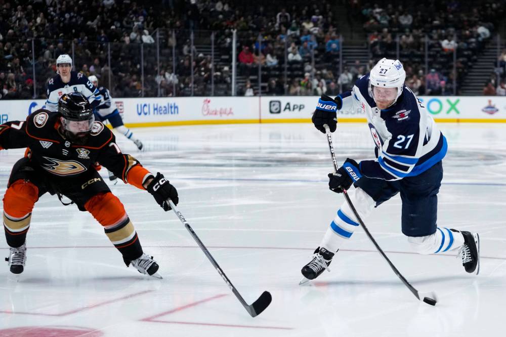 Winnipeg Jets’ Nikolaj Ehlers, right, shoots past Anaheim Ducks defenceman Radko Gudas during the second period Friday, in Anaheim. (AP Photo/Ryan Sun)
