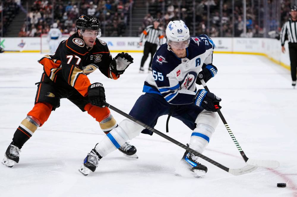 Winnipeg Jets’ Mark Scheifele, right, and Anaheim Ducks’ Frank Vatrano vie for the puck during the second period. (AP Photo/Ryan Sun)