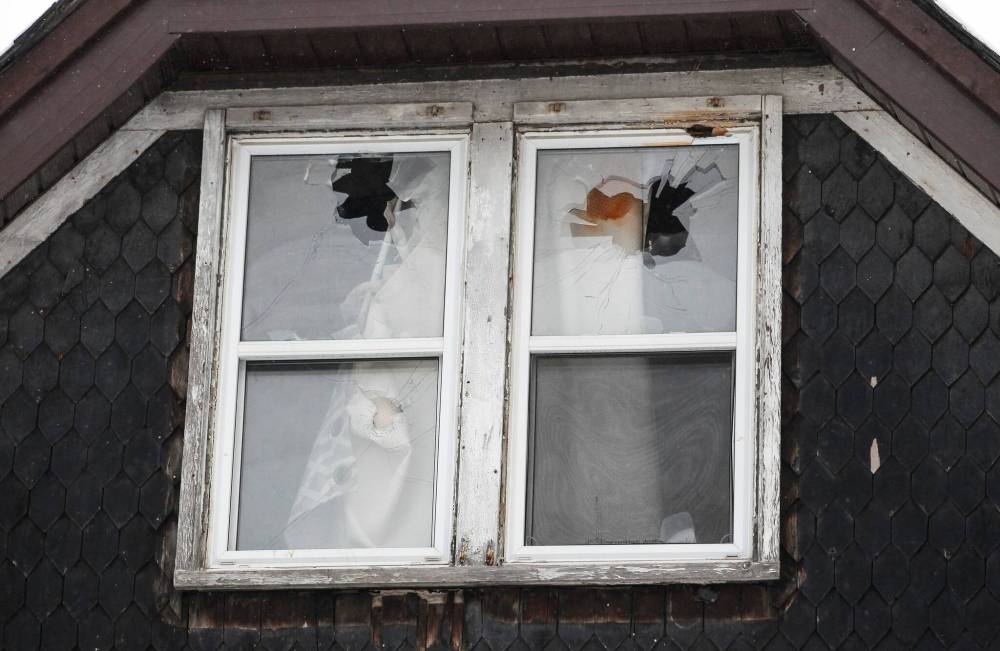 Evidence of the raid remained in the form of shattered glass, a smashed front door and a spray-painted sign warning people not to enter the home. (John Woods / Winnipeg Free Press)