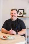 photos by MIKAELA MACKENZIE / WINNIPEG FREE PRESS
                                Josh Penner, the chef and owner of Faspa Catering & Food Market, with a plate of vareniki and farmer sausage at the new Mennonite takeout and catering business