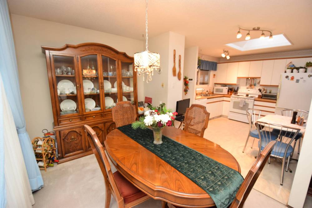Flow from the spacious dining area into the eat-in kitchen is seamless.