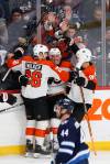 JOHN WOODS / THE CANADIAN PRESS

Philadelphia Flyers’ Sean Walker (26), Cam Atkinson (89) and Joel Farabee (86) celebrate Atkinson’s first-period goal Saturday.