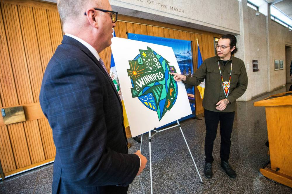 Mayor Scott Gillingham (left) and artist Jordan Stranger speak about the symbolism in the Winnipeg 150 graphic after revealing it at City Hall on Monday. (Mikaela MacKenzie / Winnipeg Free Press)